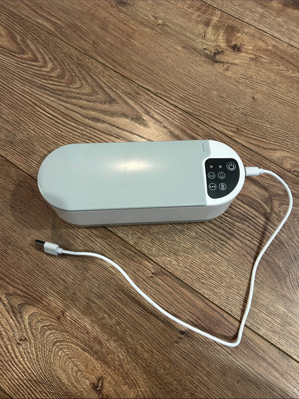 Portable White Electronic Gadget with USB Cord